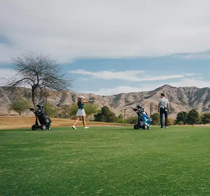 Hannah walking down the fairway with Q Follow caddie